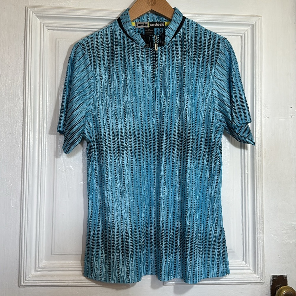 Jamie Sadock in blue and black Golf Pro Top size XL